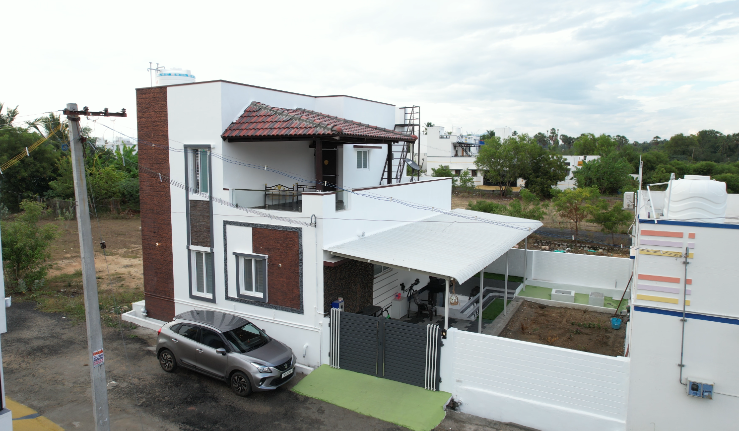 A two-storey home on its plot, car port and compound wall finished