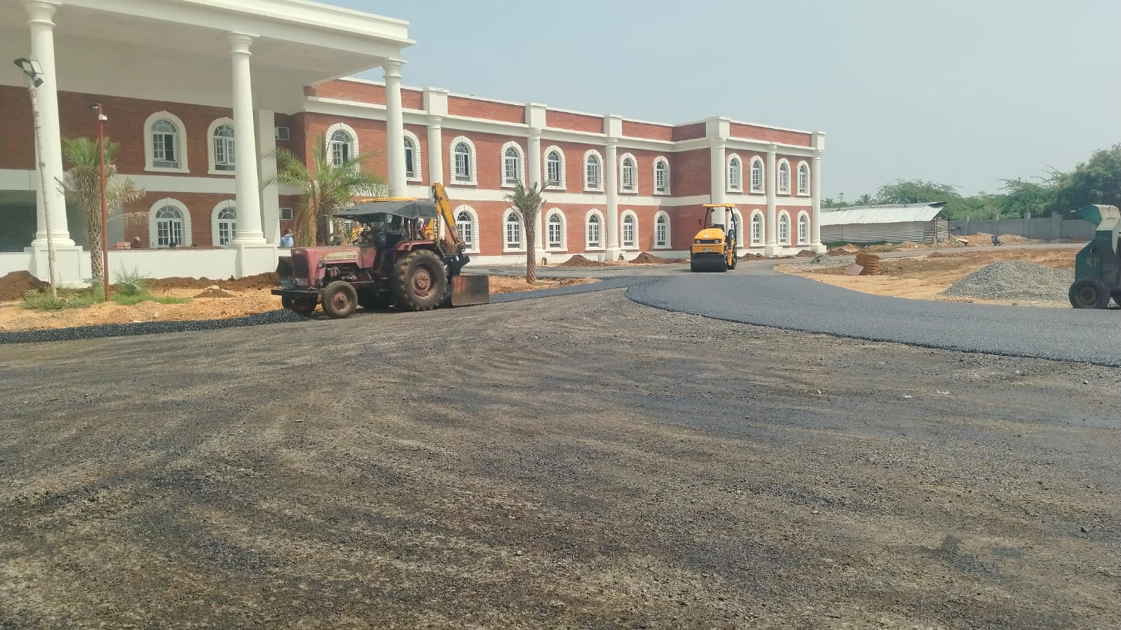 The long classroom wing seen from the far end of the campus approach